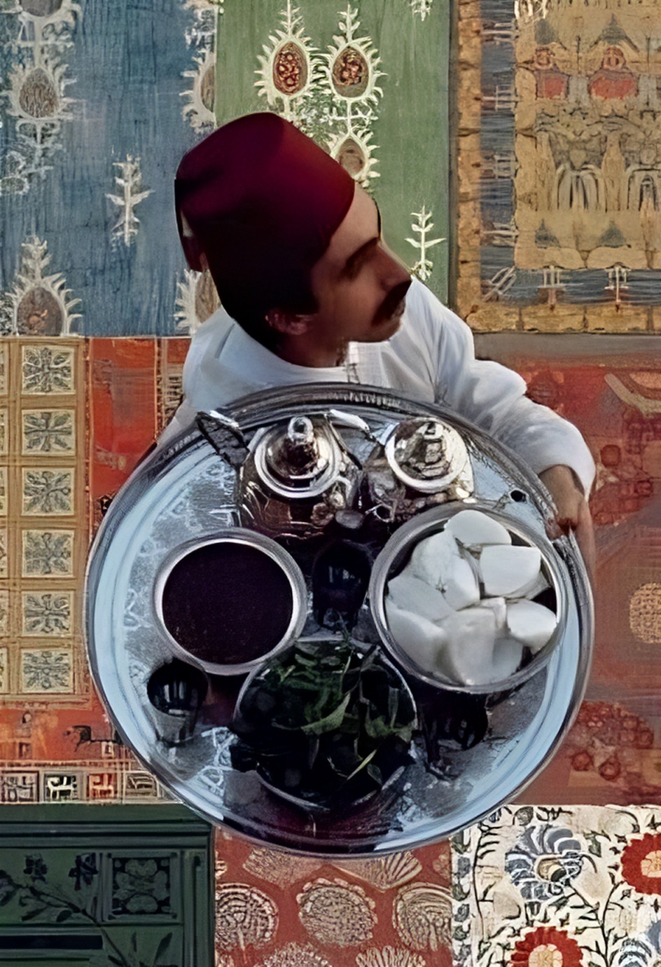 Man in red fez with Lebanese food tray
